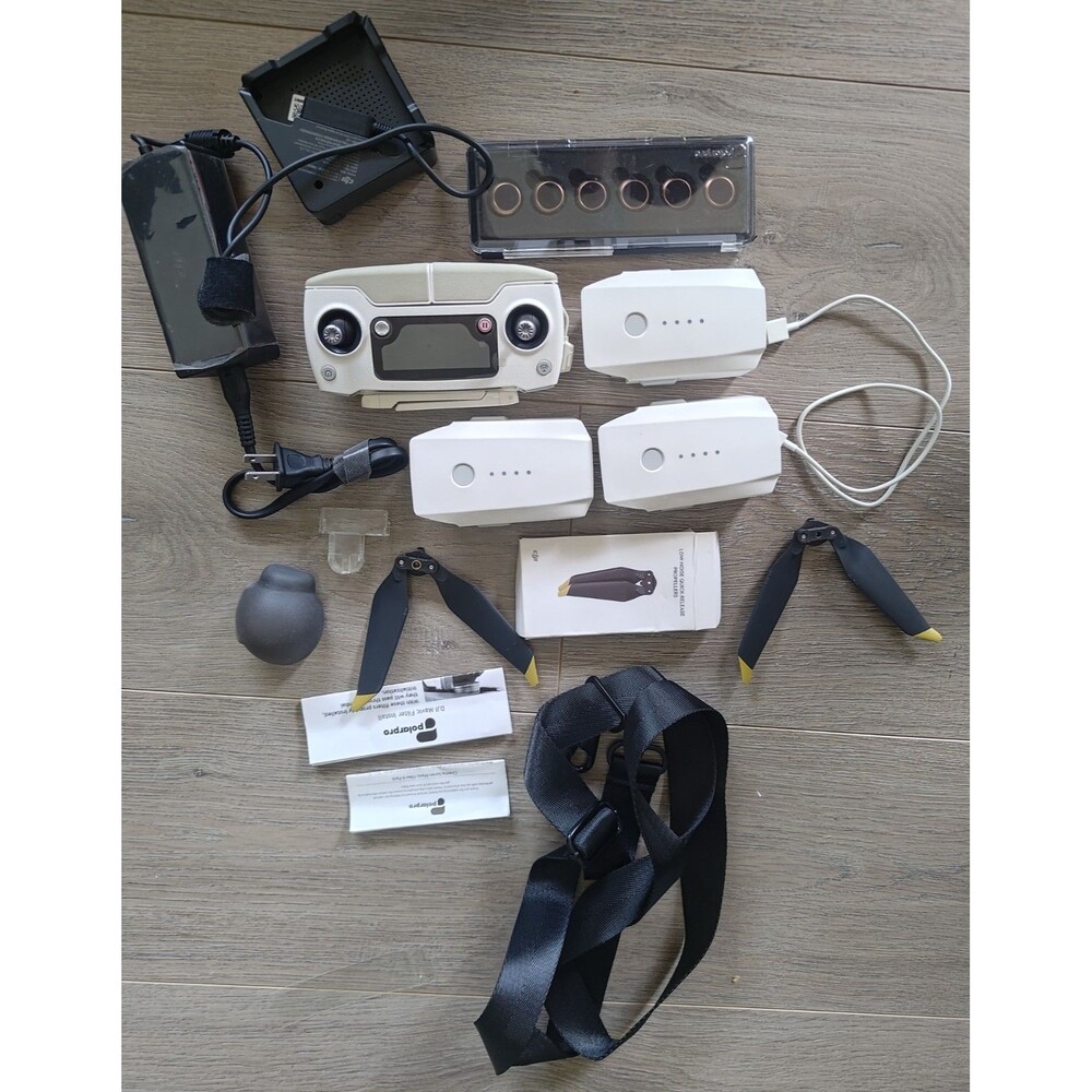 The DJI box is misc. drone remote, 3 batteries & charger and Misc parts w case